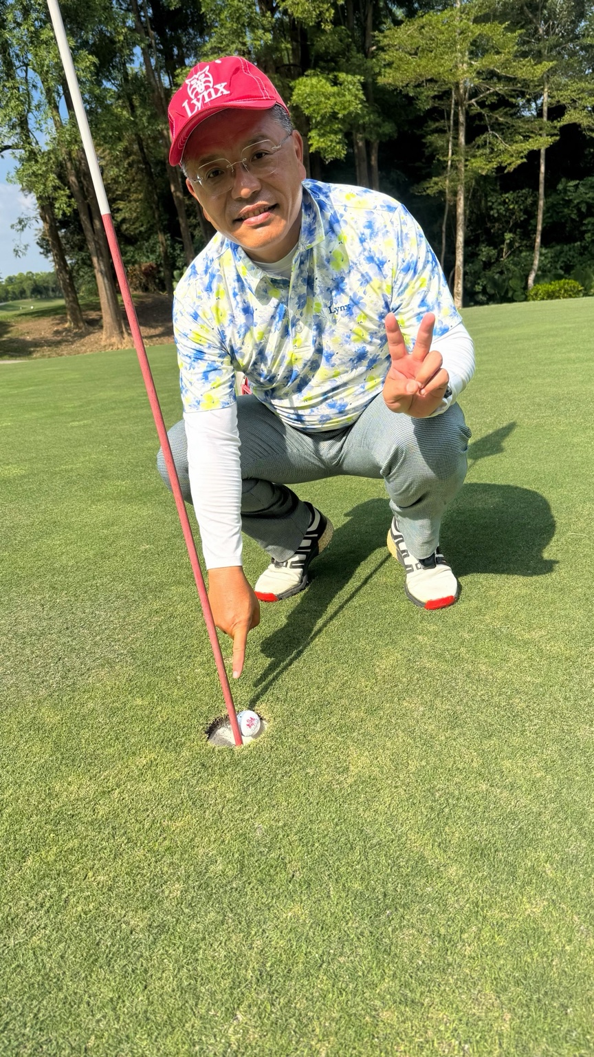 南寶球場一桿進洞紀念照：公煥忠先生在洞口旁比出勝利手勢
